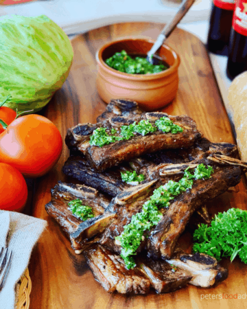 Argentine Bbq Beef Ribs - Asado style is a tasty way to enjoy your short cut ribs this summer. Flanken-style short ribs, cut cross the bone and bbq'd to perfection. Served with homemade Chimichurri sauce.
