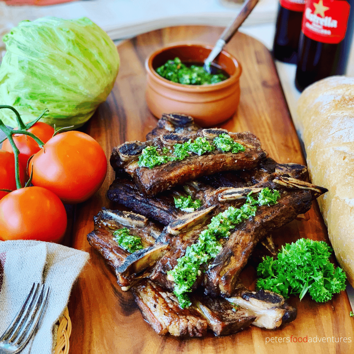 Argentine Bbq Beef Ribs - Asado style is a tasty way to enjoy your short cut ribs this summer. Flanken-style short ribs, cut cross the bone and bbq'd to perfection. Served with homemade Chimichurri sauce.