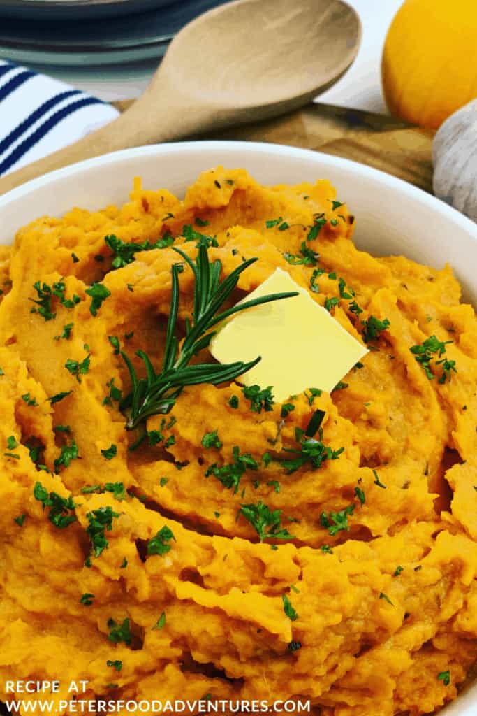 Mashed Sweet Potatoes with rosemary and butter in a bowl