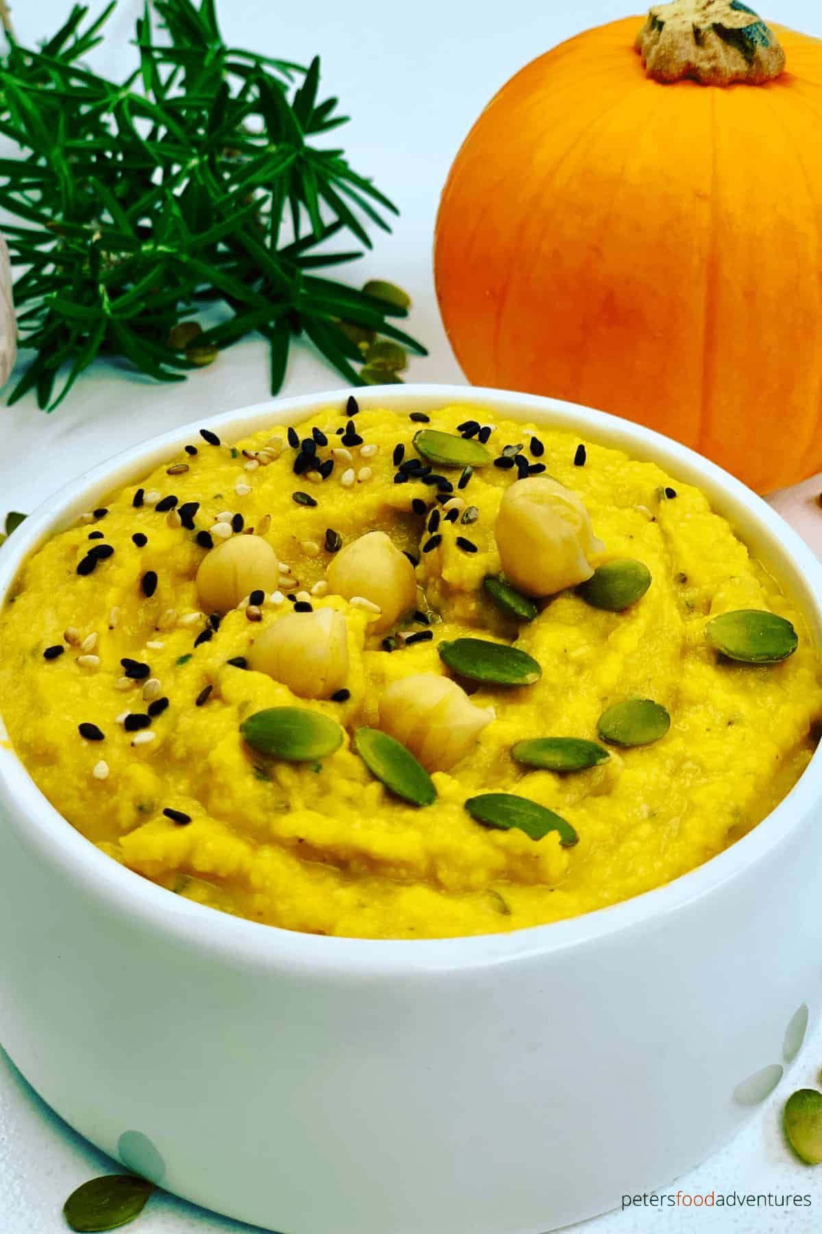 Easy Pumpkin Hummus is healthy appetizer and perfect for fall or Thanksgiving. Made in minutes, with pumpkin, chickpeas, garlic and rosemary. A vegan savory dip that everyone will enjoy.