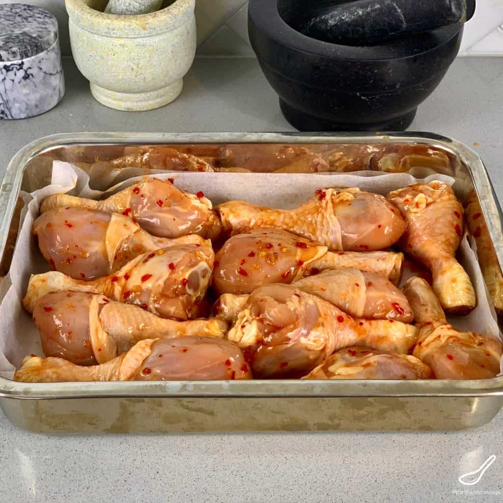 Chicken drumsticks in a baking tray ready for the oven