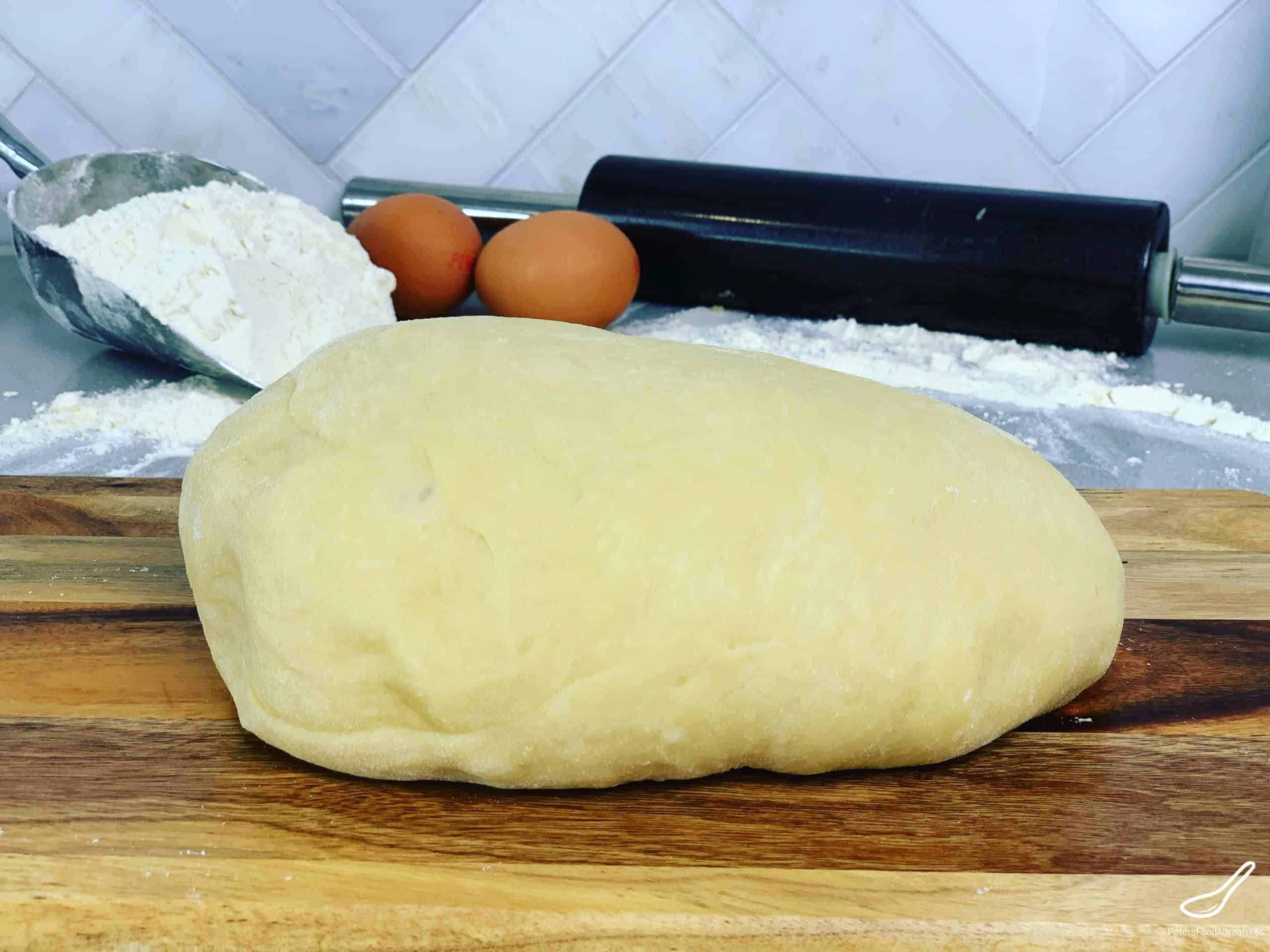Yeast dough ball with rolling pin and flour