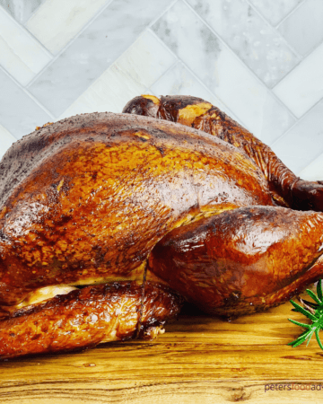 This smoked turkey is juicy and full of flavor. Brined overnight before being smoked in an offset smoker. A juicy and tender smoked turkey recipe, perfect for Thanksgiving or Christmas!