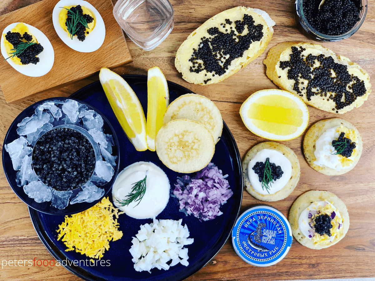 caviar platter board with blinis, breads and eggs