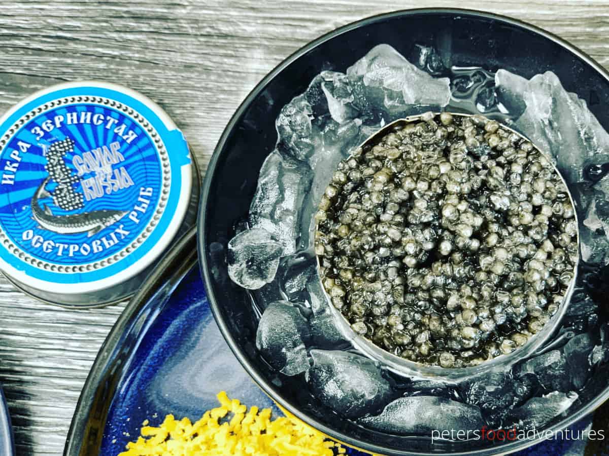 open tin of russian black caviar on ice