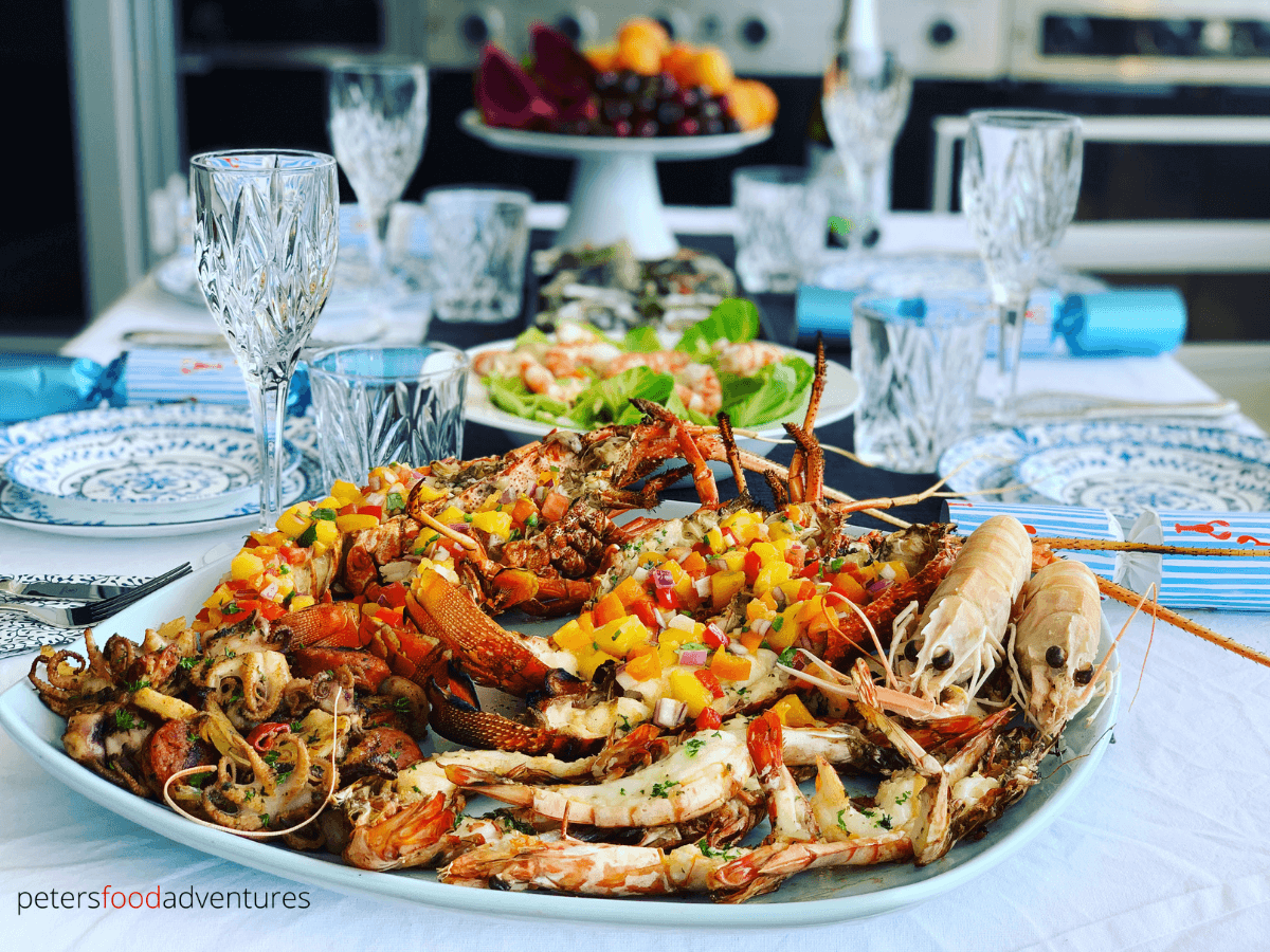 an aussie seafood feast on a platter, grilled lobsters, king prawns and octopus
