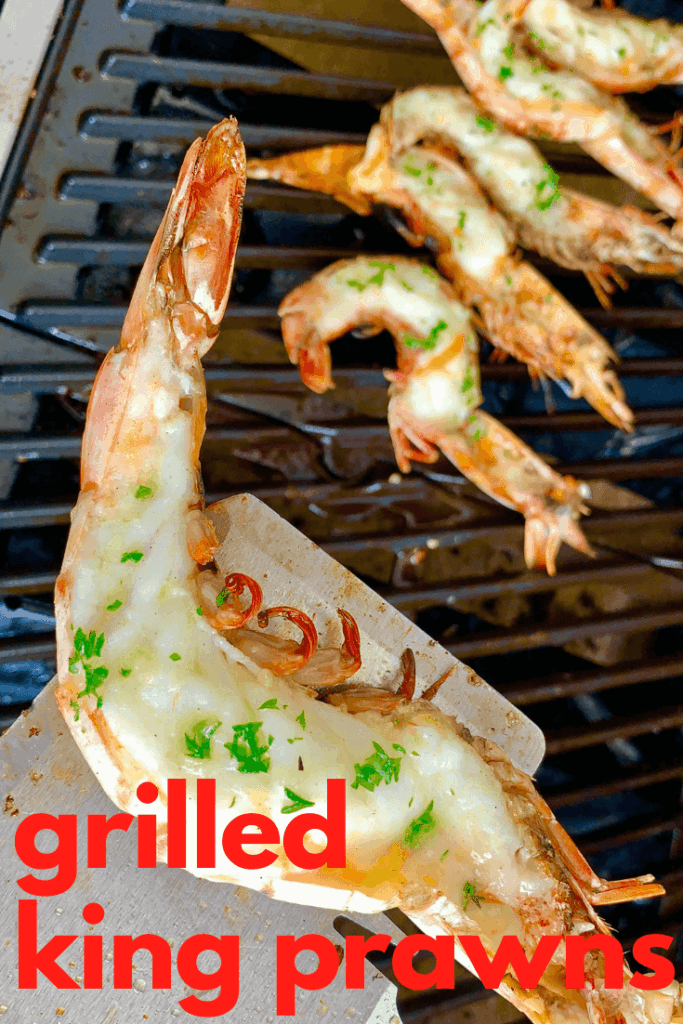 Grilled King Prawns generously slathered in garlic butter, grilled to perfection! Butterflied Shrimp on the half shell is the perfect summer bbq feast!
