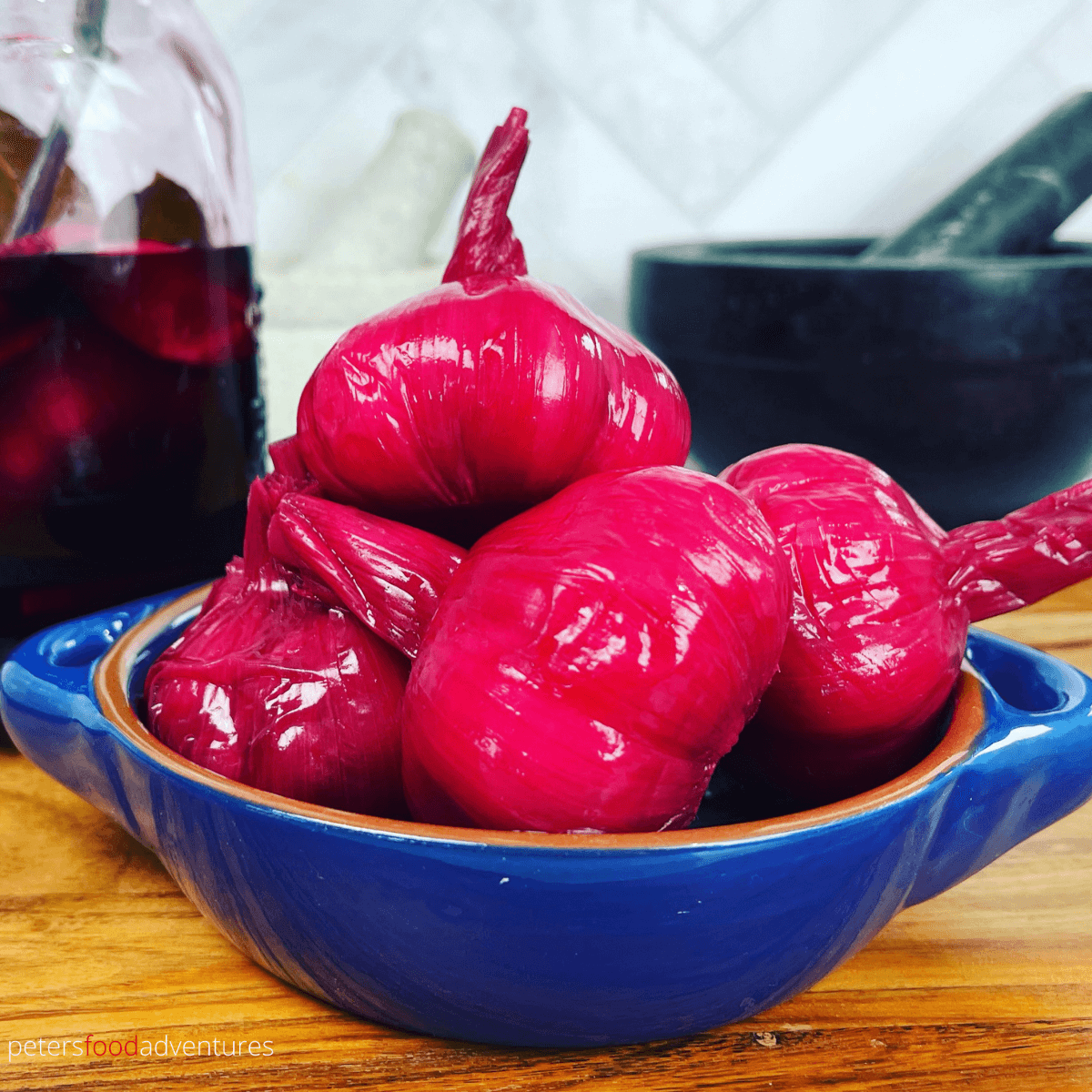 I think this is one of the coolest Pickled Garlic recipes on the internet! Bright, colorful and tasty. In Russian, we call it Marinated Garlic (Маринованный чеснок). The bright pink, almost fuchsia color of the garlic head from the pickled beets, will be the talk of the dinner table!