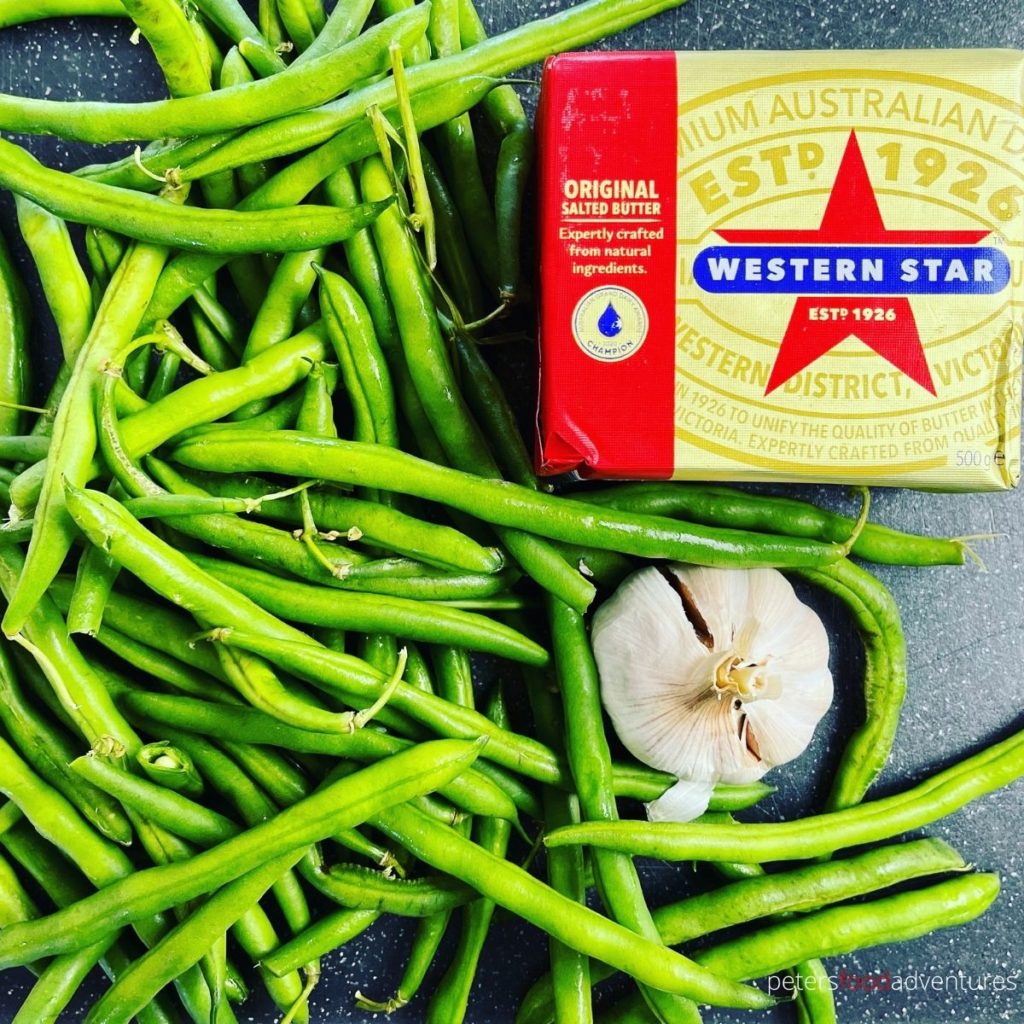 green beans, garlic can butter on a table