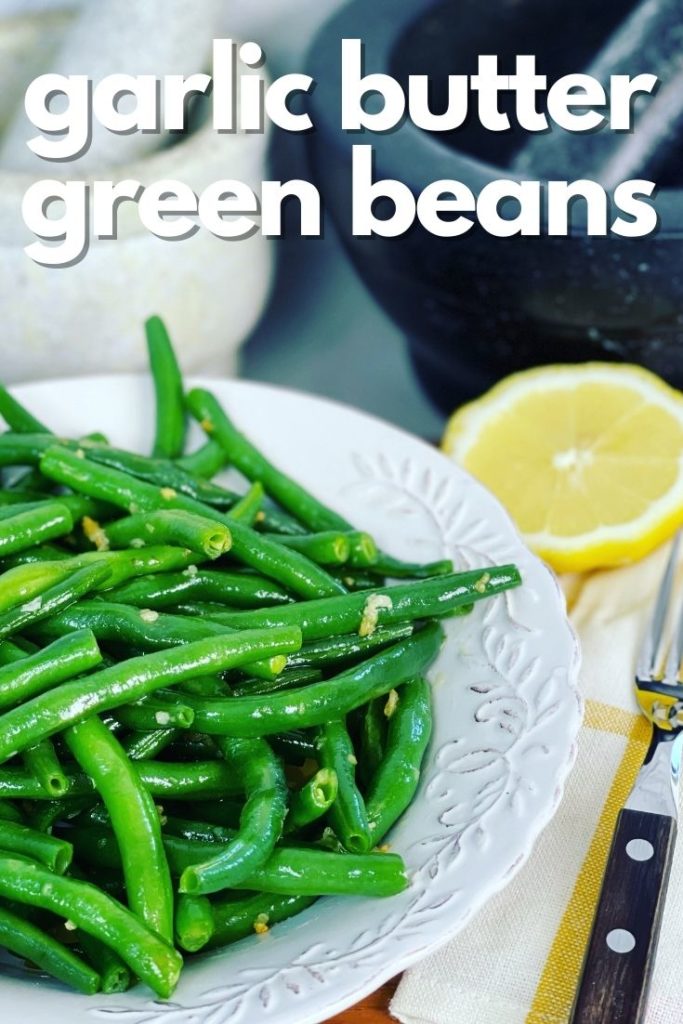 garlic butter green beans in a bowl with lemon