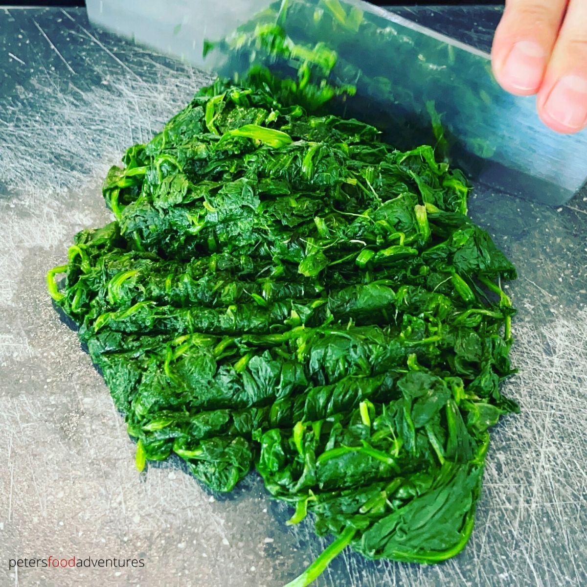 chopping steamed spinach