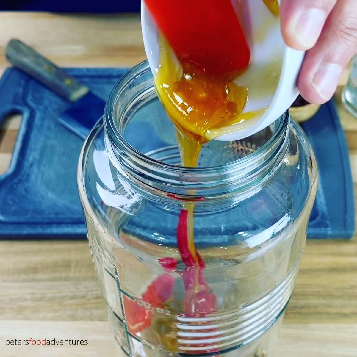 pouring honey in jar