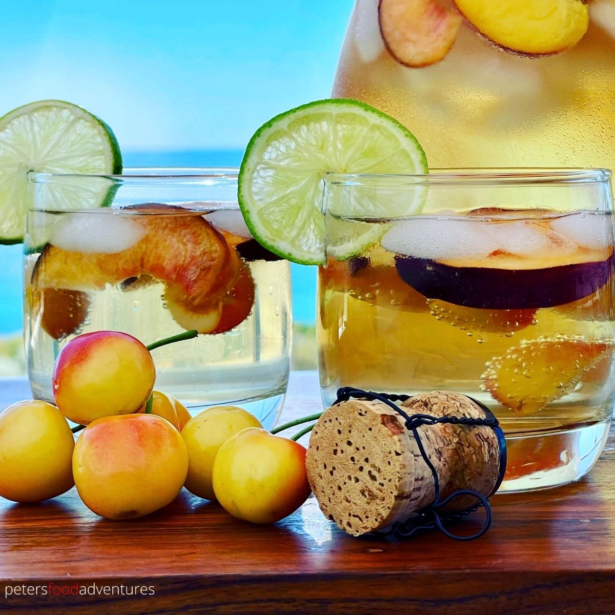 white sangria in glasses with white cherries