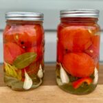 2 glass jars of canned whole tomatoes