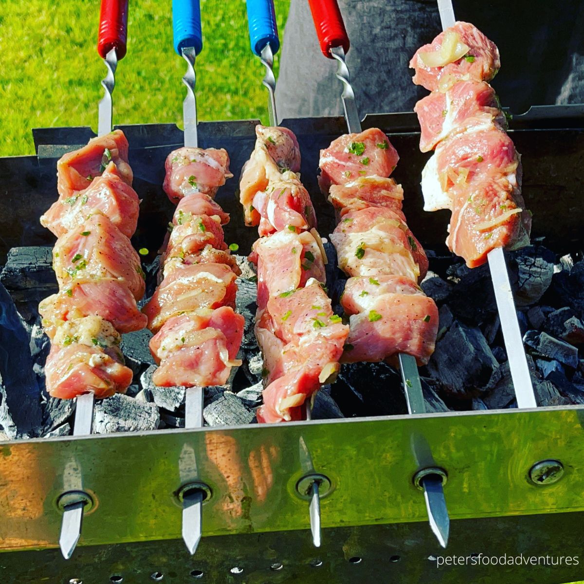 skewered kebabs cooking over grill