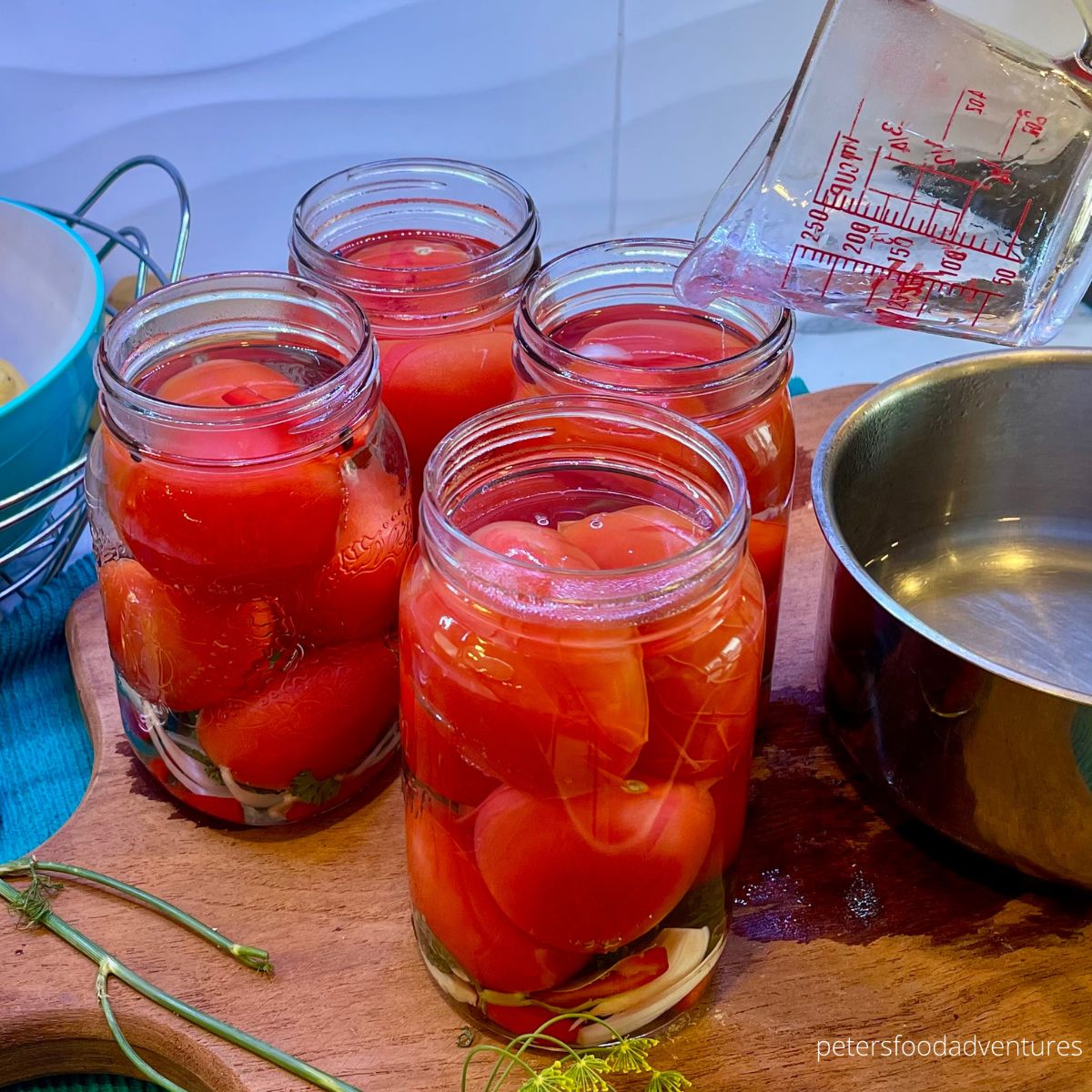 pouring brine on tomatoes