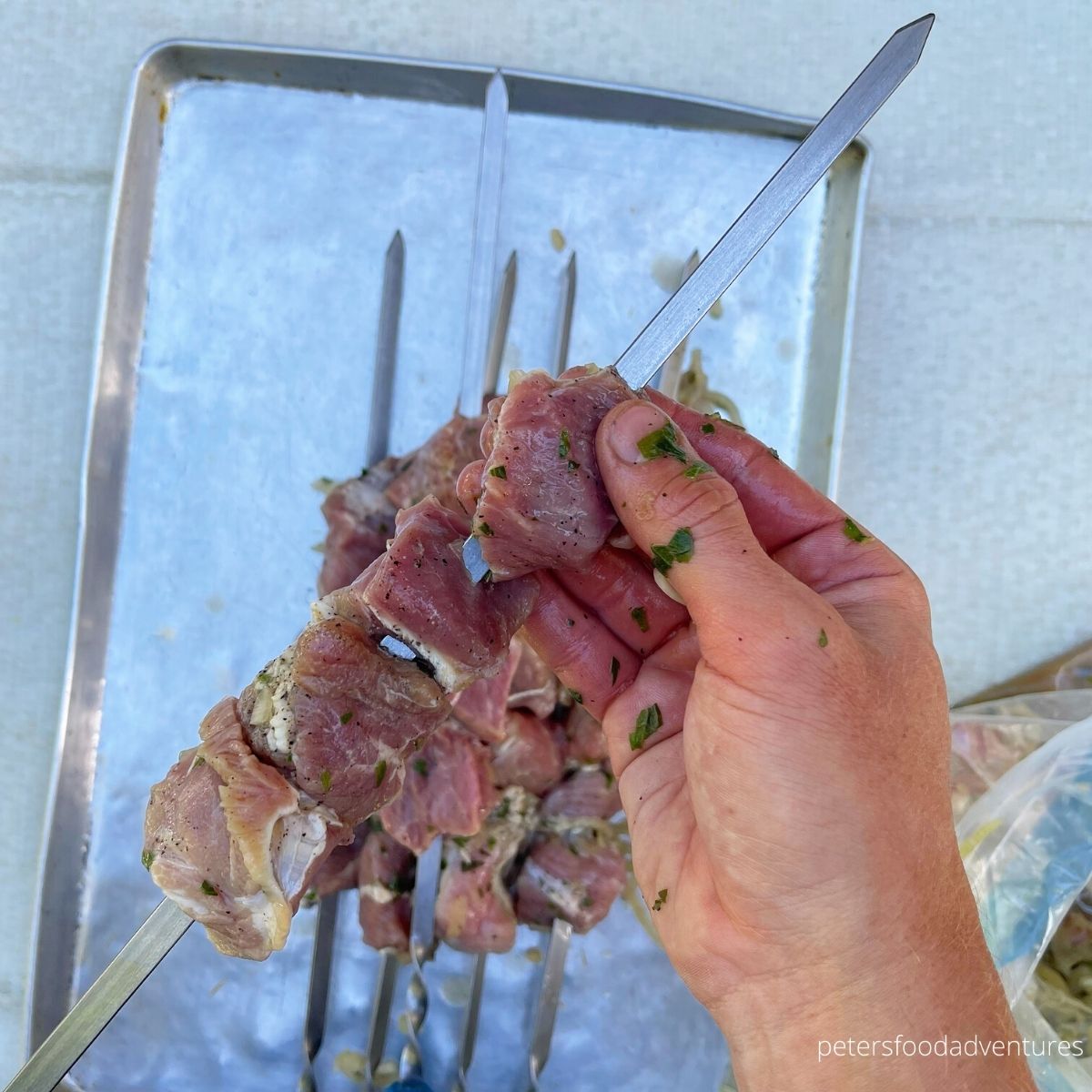 threading skewers with meat