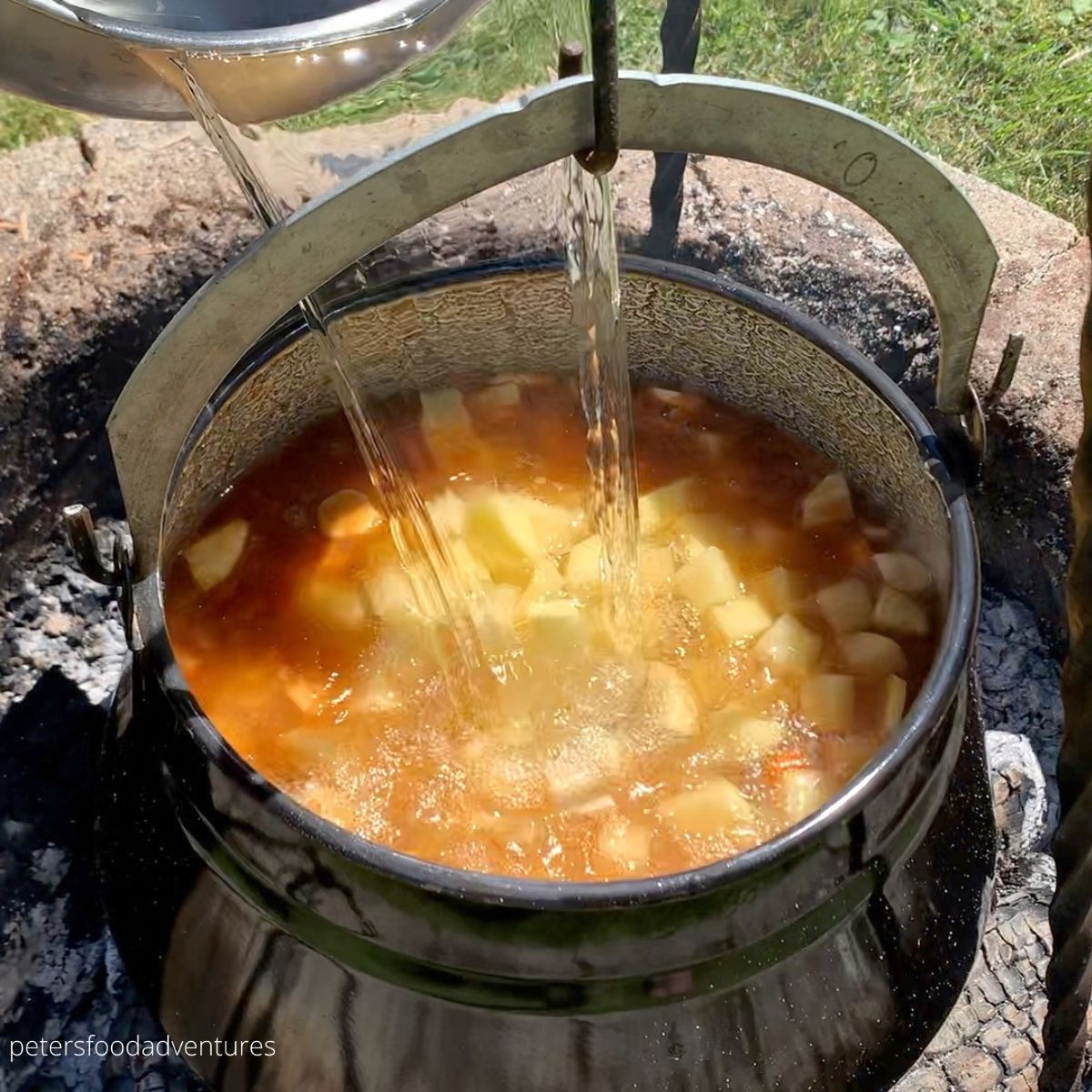 pouring water into goulash pot