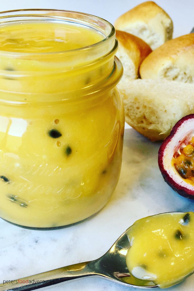 passionfruit curd in glass jar with spoon