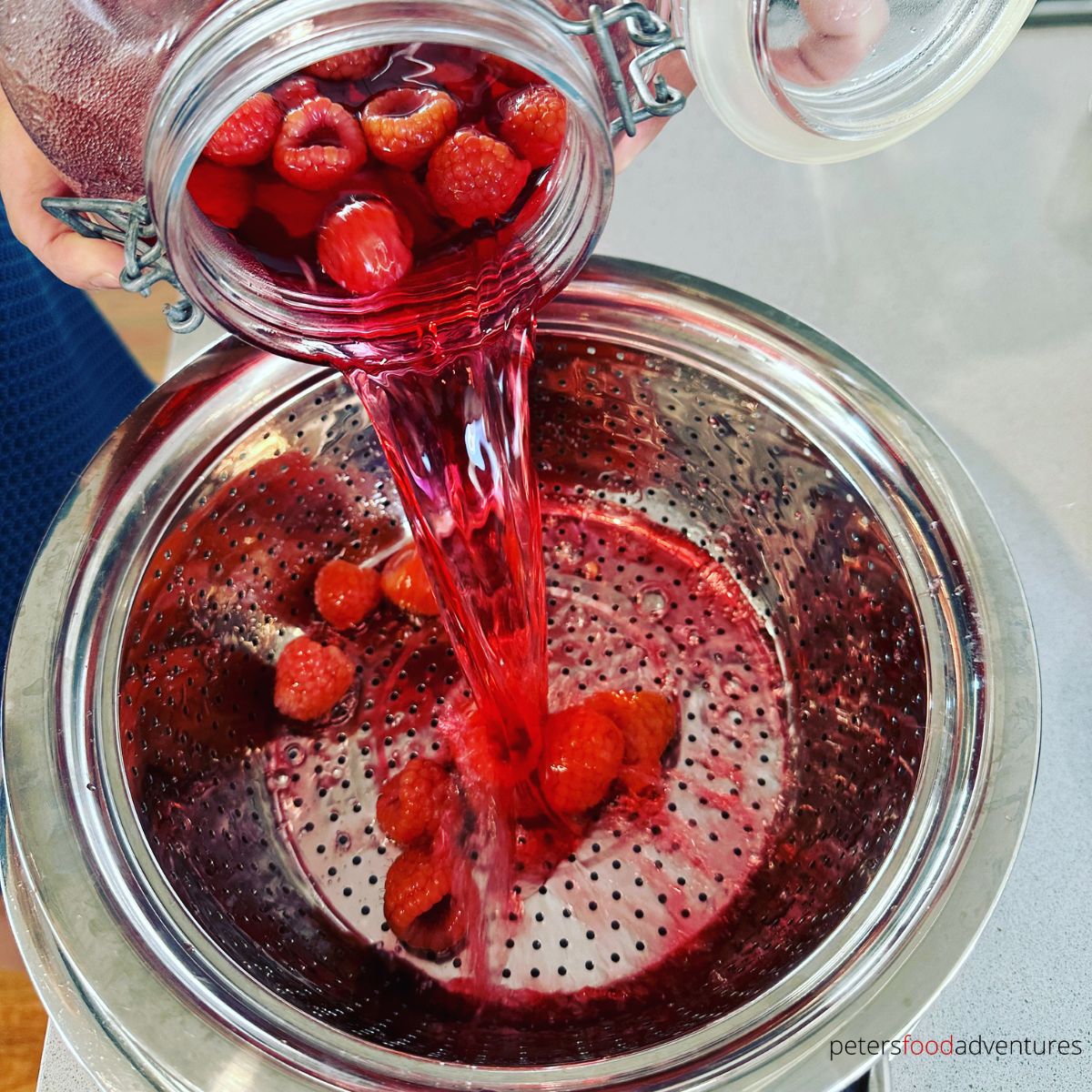 straining raspberry vodka