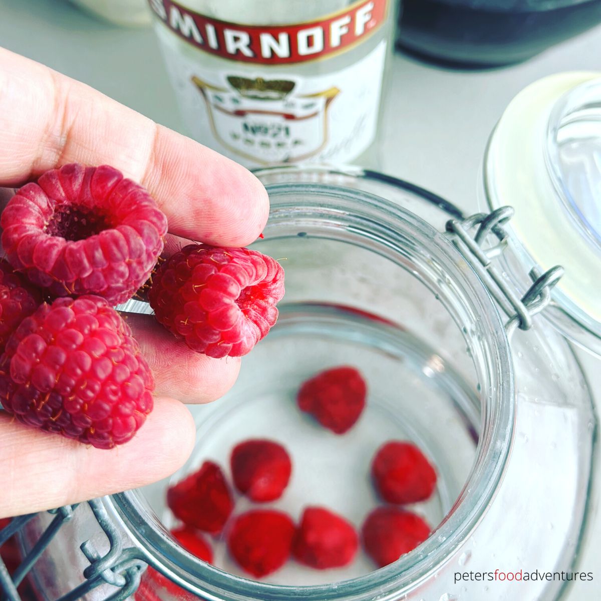 tossing raspberries in jar