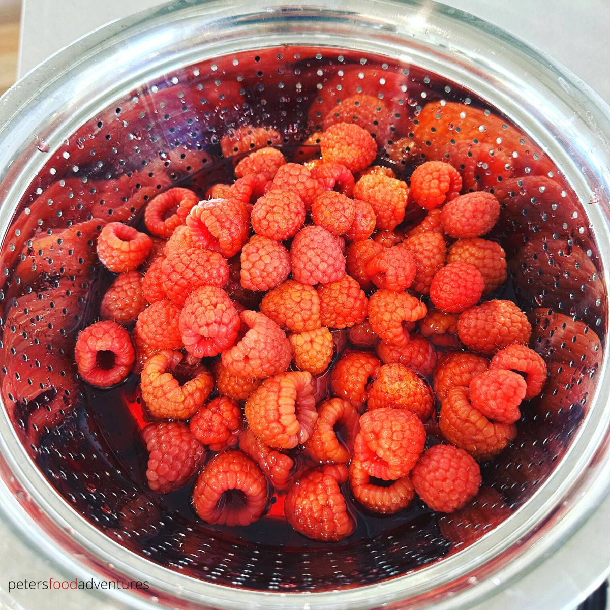 washing raspberries in strainer