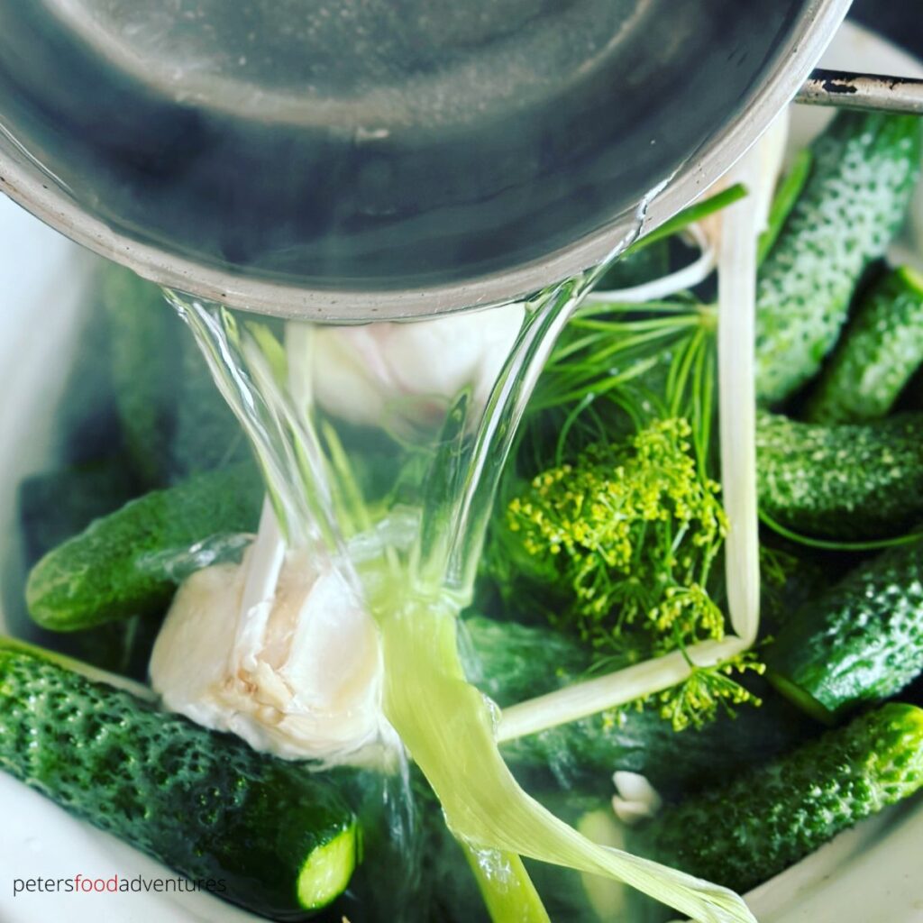 pouring brine over pickles