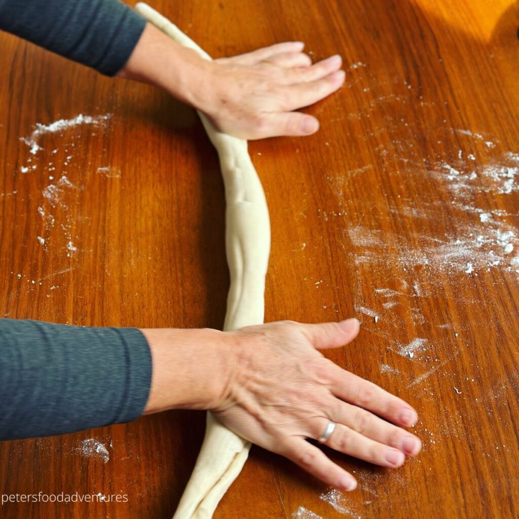 hand rolling dough into strands