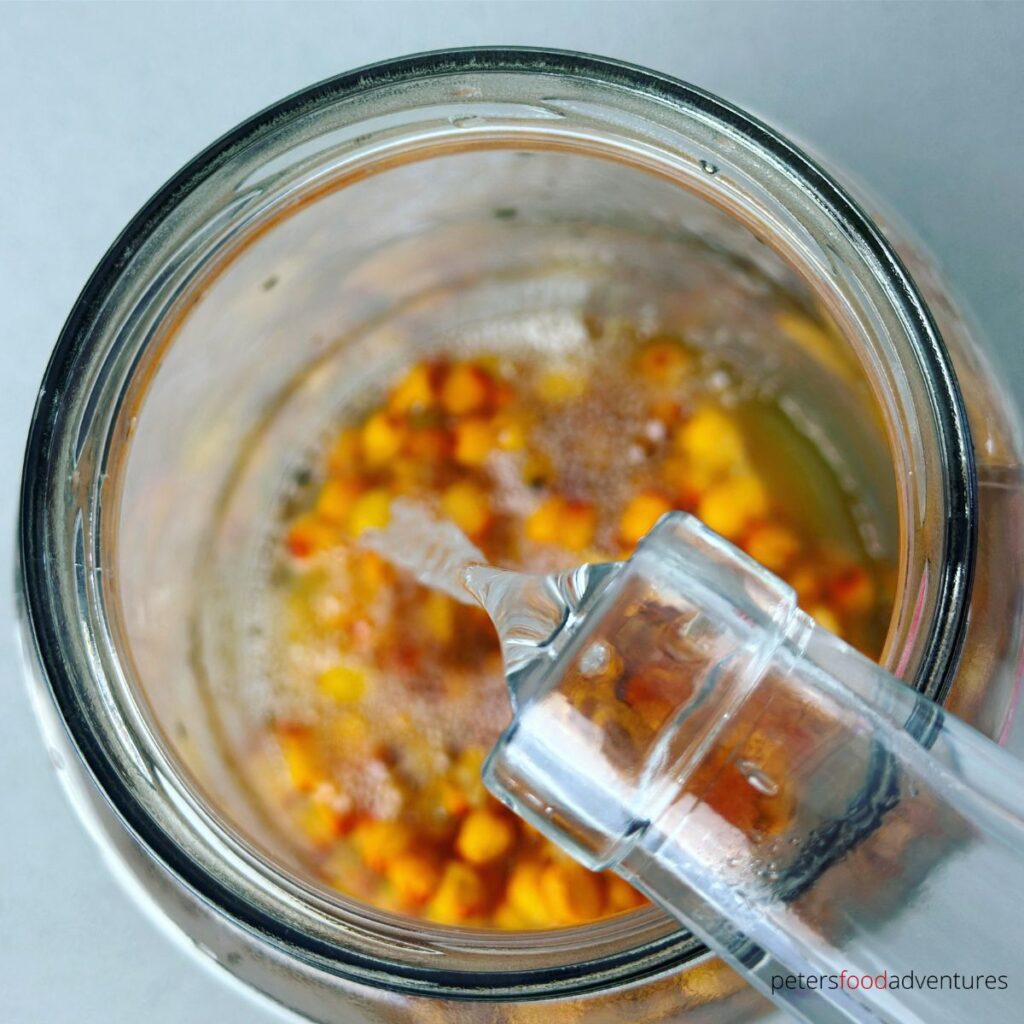 pouring vodka in jar